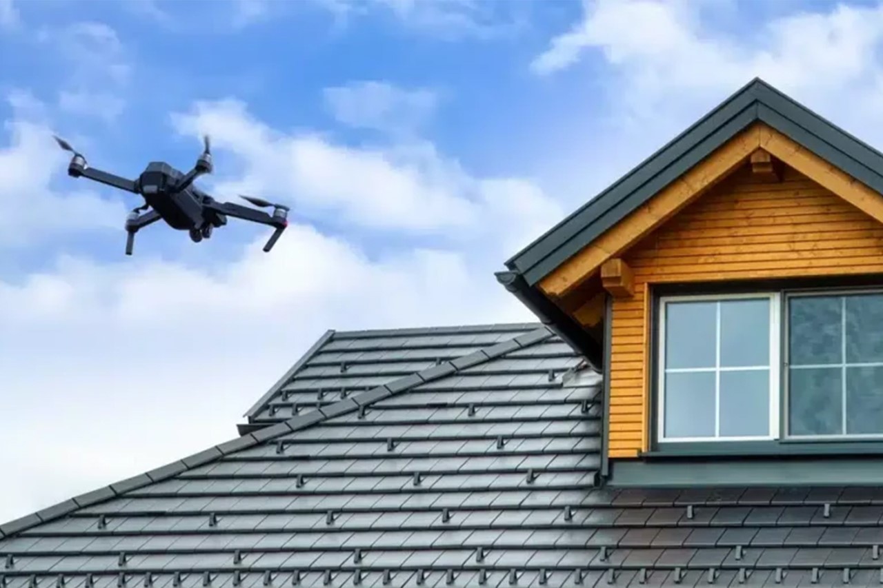Drone capturing aerial photos of a roof for inspection