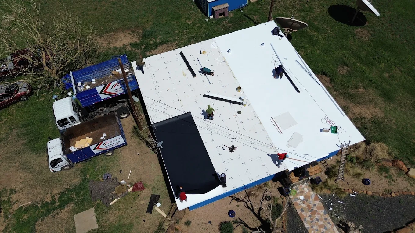 White TPO membrane being installed on a low-slope roof